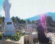 On Apparition Hill in Medjugorje, Father David, the miracle working Capuchin priest, who has Stigmata wounds on his hands and feet, WILL OFFER 365 MASSES FOR YOU AND YOUR FAMILY AND FOR ALL OF YOUR INTENTIONS, is shown here in front of the Blessed Virgin Mary Statue. 